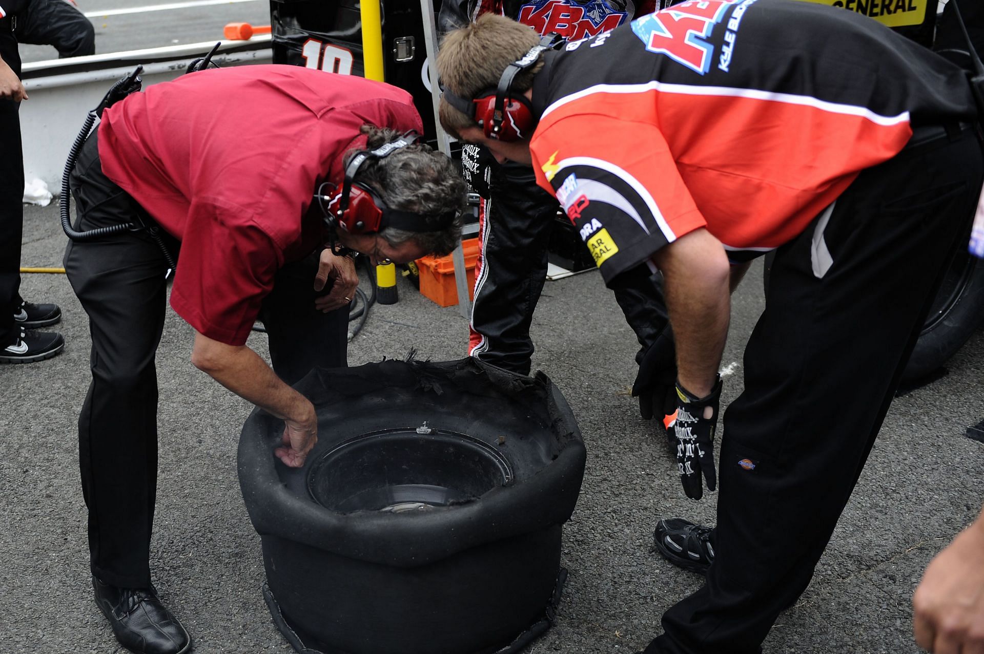 NASCAR GM Rick Ren inspects Kyle Busch's #18 Toyota tire in 2011 at Pocono Raceway. Source: Getty